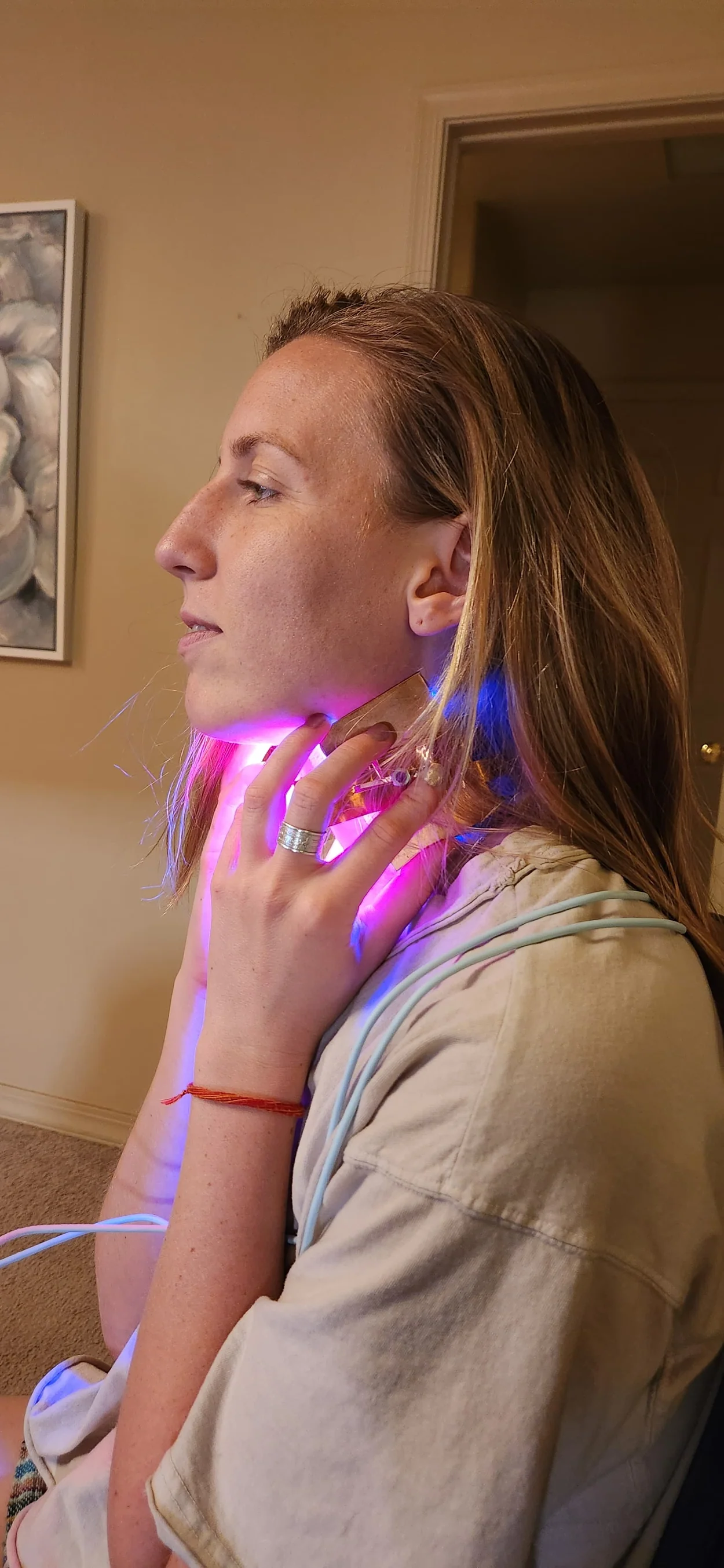 Annie using the device on her neck